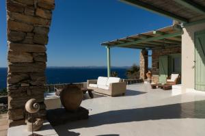 an outdoor patio with a view of the ocean at Villa Martha in Kea in Koundouros