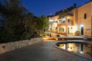 a house with a swimming pool at night at Agathes Traditional Houses in Kástellos