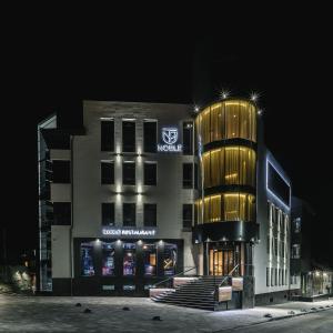 a building with a sign on the side of it at Noble Boutique Hotel in Luts'k