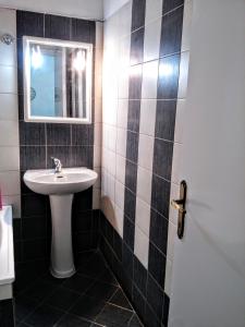 a bathroom with a sink and a mirror at Traditional penthouse with mountain view in Grevena