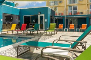 a group of chairs next to a swimming pool at Holiday Inn Express & Suites Nassau by IHG in Nassau
