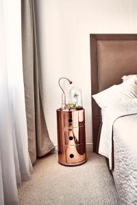 a wooden night stand sitting next to a bed at Forest Park by Zoom Apartments in Bratislava