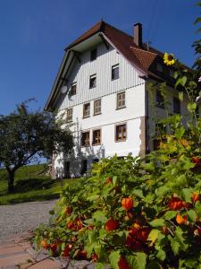 a large white building with flowers in front of it at Fehrenbacherhof Naturgästehaus in Lauterbach