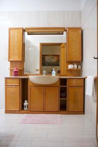 a bathroom with a sink and a mirror at Domus Palombi in Ladispoli