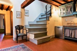 a staircase in a kitchen with a table and a chair at L'antico granaio in Forcoli