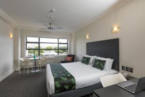 a hotel room with two beds and a television at Quest Napier Serviced Apartments in Napier