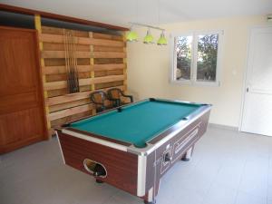 a pool table in a living room with at Auberge du Saut des Cuves in Xonrupt-Longemer