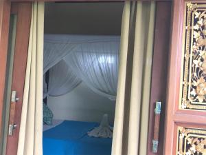Postel nebo postele na pokoji v ubytování Arya Homestay