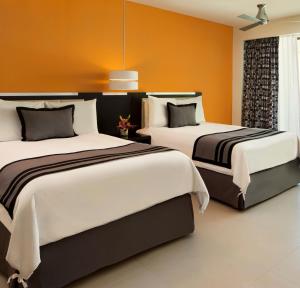 Postel nebo postele na pokoji v ubytování Dreams Huatulco Resort & Spa