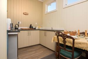 a kitchen with a table and a counter top at Sennen House Boutique Accommodation in Picton