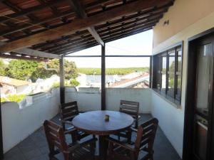 a patio with a table and chairs on a balcony at Aparthotel BahiaTropical in Canavieiras