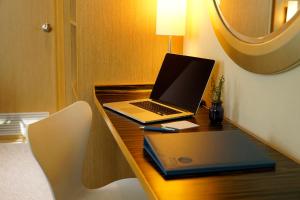 a laptop computer sitting on a desk in a room at Hotel COZi Harbour View in Hong Kong