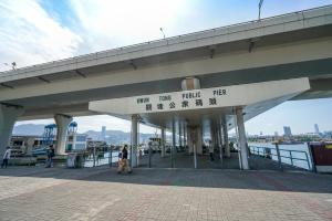 a bridge with a sign that reads inn the riding pier at Hotel COZi Harbour View in Hong Kong