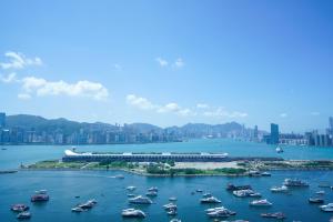 a group of boats in a harbor with a city at Hotel COZi Harbour View in Hong Kong