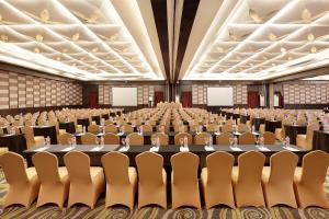 an empty banquet hall with tables and chairs at Swiss-Belhotel Balikpapan in Balikpapan +127 photos
