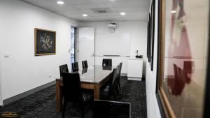 a conference room with a table and chairs at Crown on Darby Newcastle in Newcastle