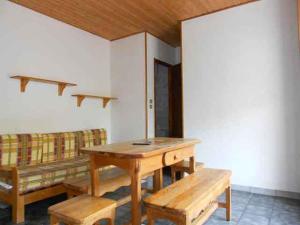 a room with a table and benches and a couch at Résidence du Chajoux in La Bresse +43 photos
