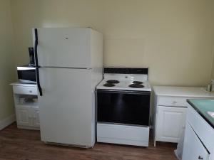 a kitchen with a white refrigerator and a stove at A Sapphire Inn in Franklin