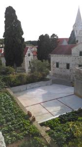 a large concrete patio in front of a building at Guest House Marija in Sumartin
