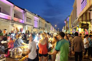 a crowd of people standing around a street market at The Besavana Phuket - SHA Extra Plus in Phuket Town +37 photos