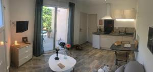 a kitchen with a table and a kitchen with a window at Carpédiem in Sanary-sur-Mer