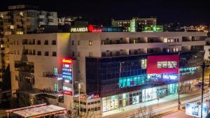 a building with lights on the side of it at night at Mostar PC Piramida in Mostar