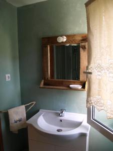 a bathroom with a sink and a mirror at Villa Emma in Agia Fotia +40 photos