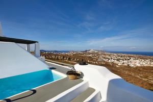 a villa with a swimming pool and a view of the ocean at Carpe Diem Santorini in Pyrgos