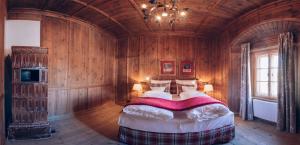 a bedroom with a large bed in a wooden room at Mellauner Hof in Pettnau