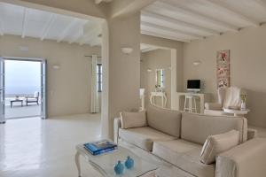 a living room with a couch and a table at Carpe Diem Santorini in Pyrgos