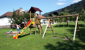 a group of children playing on a playground at Appartement Mühle in Kaprun