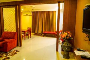 a living room with a couch and a table at Hotel Horizon International in Guruvāyūr