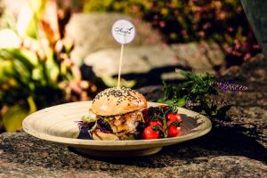 a plate of food with a sandwich and vegetables at Euro HotelS in Zielona Góra