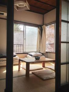 a room with a bench in front of a window at Traditional Japanese house by Waseda, Shinjuku in Tokyo