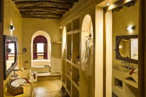 a bathroom with a sink and a toilet and a tub at Riad Chbanate in Essaouira