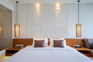Postel nebo postele na pokoji v ubytování G Hua Hin Resort & Mall