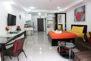 a living room with a bed and a couch and a table at View Talay 6 Suite Apartments in Pattaya Central