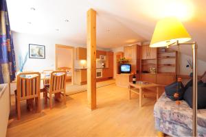 a living room with a kitchen and a dining room at Haus Enzian in Sankt Anton am Arlberg