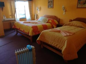 Postel nebo postele na pokoji v ubytování Hotel Utama