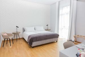A bed or beds in a room at 200 ROOMS & TERRACE