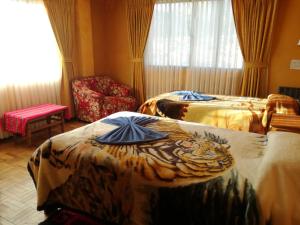 Postel nebo postele na pokoji v ubytování Hotel Utama