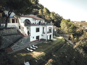 an aerial view of a white house on a hill at Villa Crawford in San Nicola Arcella