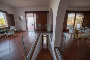 a staircase in a room with a table and chairs at Villa Crawford in San Nicola Arcella
