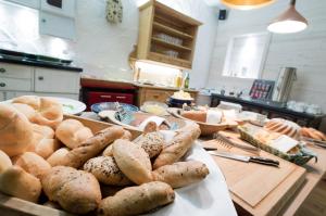 a kitchen with a table with lots of bread and vegetables at Hotel Fahrnberger in Göstling an der Ybbs