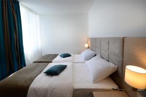Ein Bett oder Betten in einem Zimmer der Unterkunft Grand Hotel Adriatic II