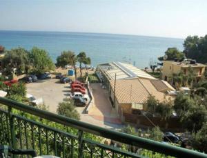 a balcony with a view of a parking lot and the ocean at Glyfada Beach Hotel in Glyfada