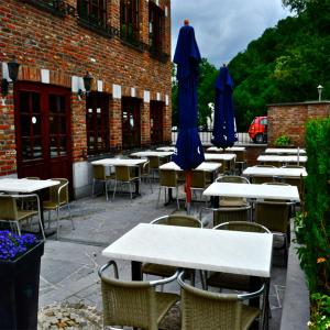 a row of tables and chairs with umbrellas at Hotel IL Castellino in Chaudfontaine