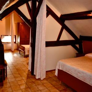 a room with a bedroom with a bed and a room with at Hotel IL Castellino in Chaudfontaine