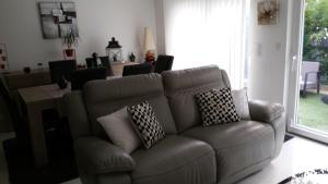 a living room with a couch with pillows on it at La Vénitienne in Colmar +1 photo