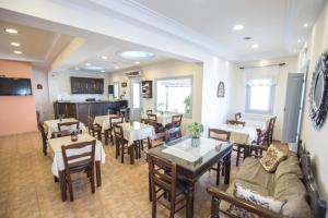 a dining room with tables and chairs and a room with tables and chairsktop at Anemoessa Villa in Oia